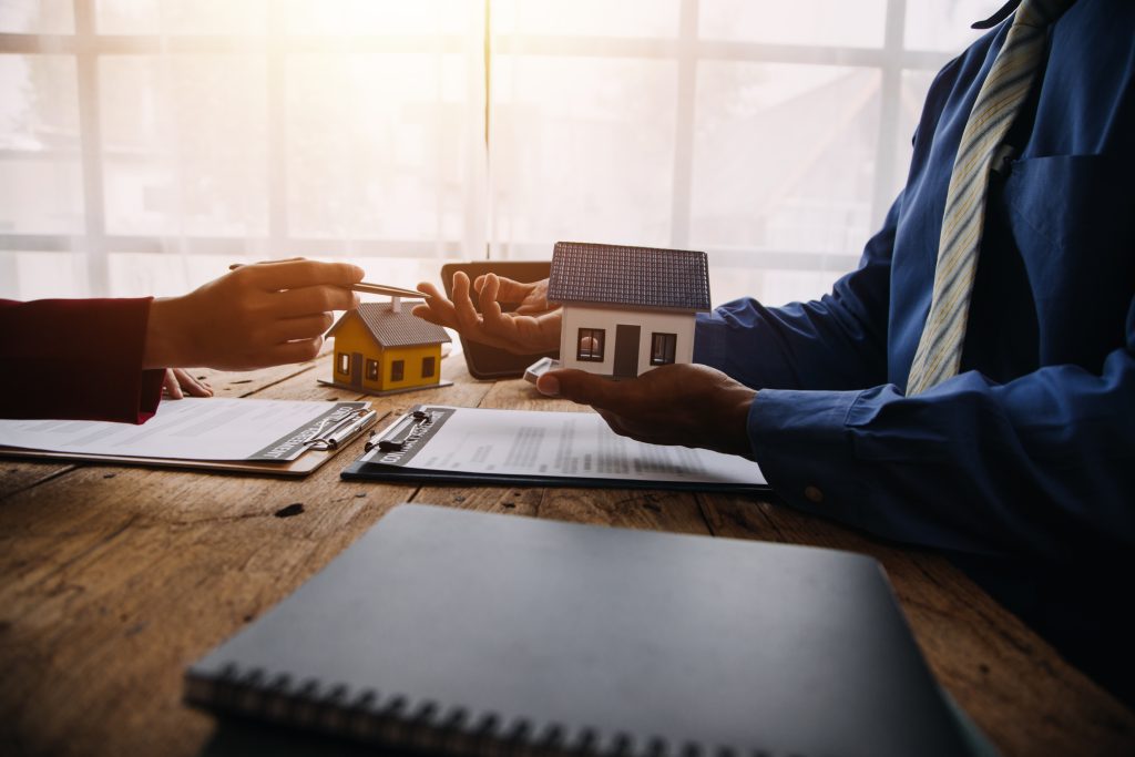 Real estate agent reviewing a title insurance agreement with a client