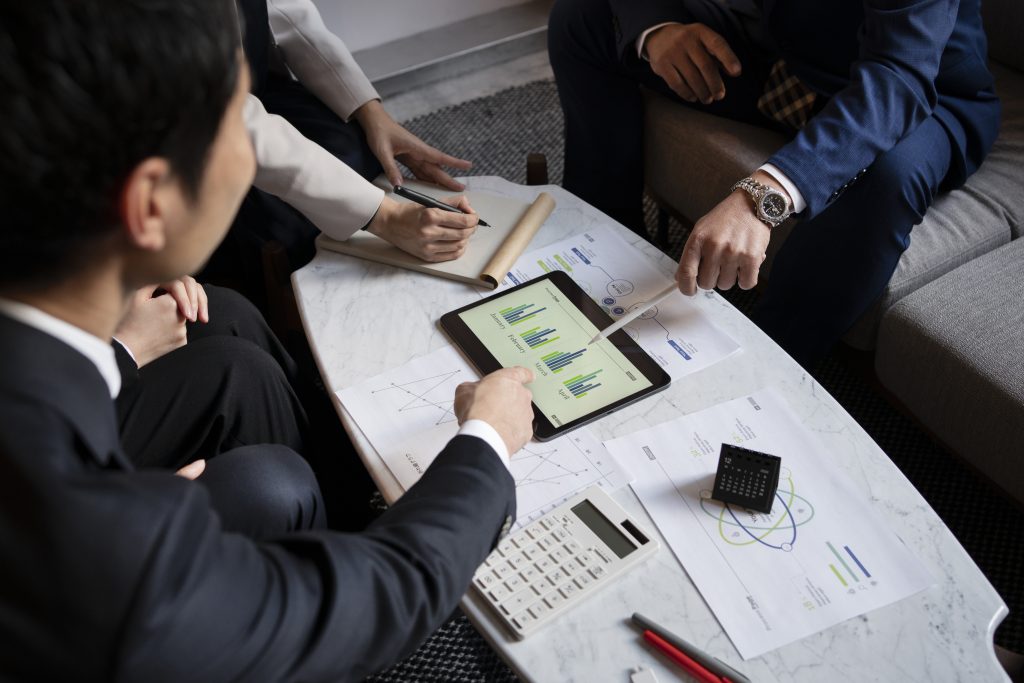Business team reviewing documents on a tablet
